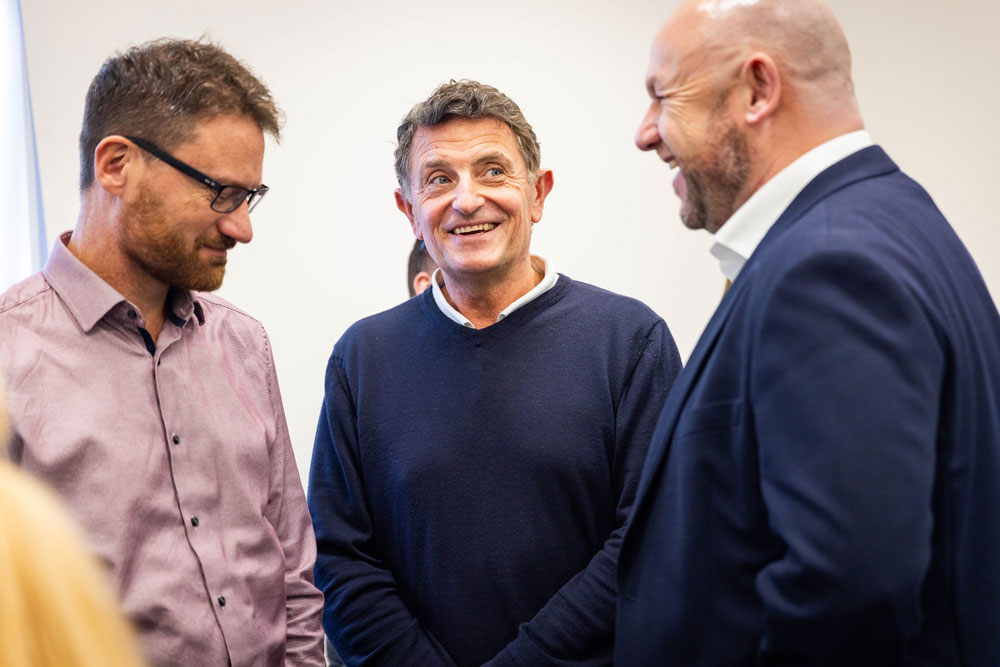 Three people chatting